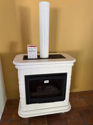 a white stove sitting in a room next to a yellow wall