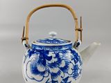 blue and white porcelain teapot with bamboo handle