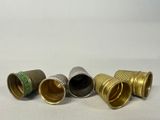 four different types of thimbles are lined up on a white surface