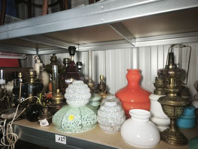 a shelf with many different types of vases on it