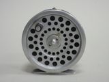 a metal object with holes on it on a white surface