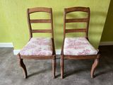 two chairs that are next to each other on the floor