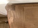 a toilet with a wooden seat in a bathroom