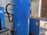 a large blue tank sitting next to a small blue machine