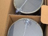 three empty tins in a box with a tag on them