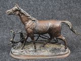 a bronze statue of a horse and a man on a cart