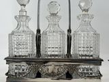 three glass decanters sitting on a silver tray