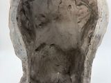 a sculpture of a face in the middle of a rock