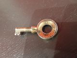 a metal key that is sitting on a table