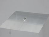 a small diamond sitting on top of a clear box