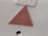 a white plate with a pink triangle and a red triangle on it
