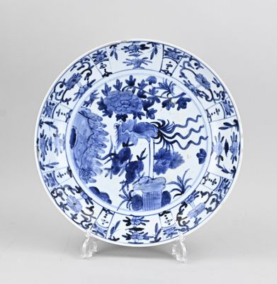 blue and white plate with flowers and birds on it