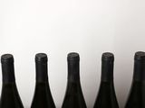 several bottles of wine are lined up on a table