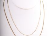 a close up of a mannequin with a necklace on it