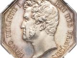 une vieille pièce d'argent sur laquelle figure le portrait d'un homme