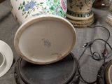 a table with a lot of vases and plates on it