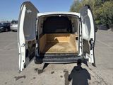 a white van with its doors open in a parking lot