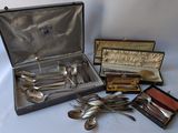 many silverware items in a case on a table