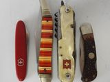 four different types of swiss army knives lined up on a white surface