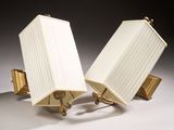 pair of brass table lamps with white lampshads on a white surface