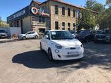 a small white car parked in front of a building