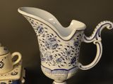 a blue and white vase and a teapot on a table