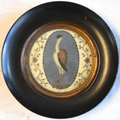 a picture of a bird on a plate on a table