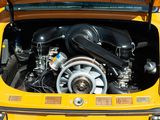 a small yellow car with a big engine in the trunk