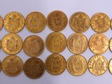 a close up of a bunch of gold coins on a white surface