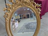 a mirror that is sitting on the ground in front of a table