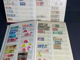 an open book with stamps on it sitting on a table