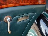 a close up of a green car door handle