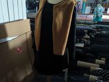 a mannequin with a coat on it in a room
