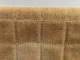 a close up of a tan purse with a zipper on it