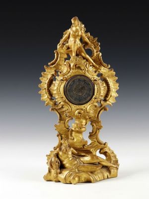 an image of a gold clock sitting on top of a table