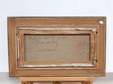 an old wooden easel with a piece of paper on top of it