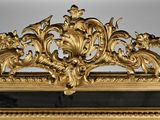 a gold frame with a mirror and a clock on it