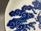 a blue and white plate with a dragon on it