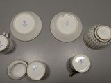a group of cups and saucers sitting on a table