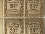 four brown and white postage stamps on a piece of paper