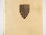 an old book with a gold shield on it