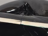 the underside of a black whale with a white stripe on it ' s tail