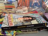 a lot of comic books on the table
