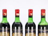 three bottles of wine are lined up on a table