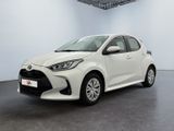 a white toyota yaris parked in a large room