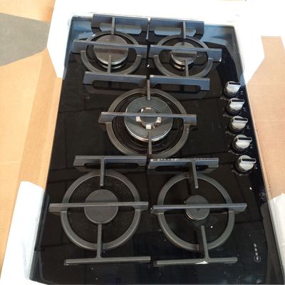 a black stove top with four burners in a box