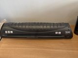 a remote control sitting on top of a wooden desk