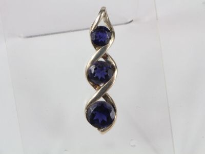 a close up of a pair of earrings with blue stones