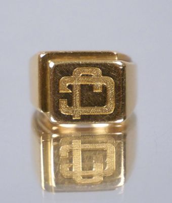 an image of a gold ring with the letter g on it