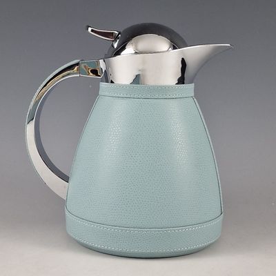 a tea pot with a teapot in it on a table